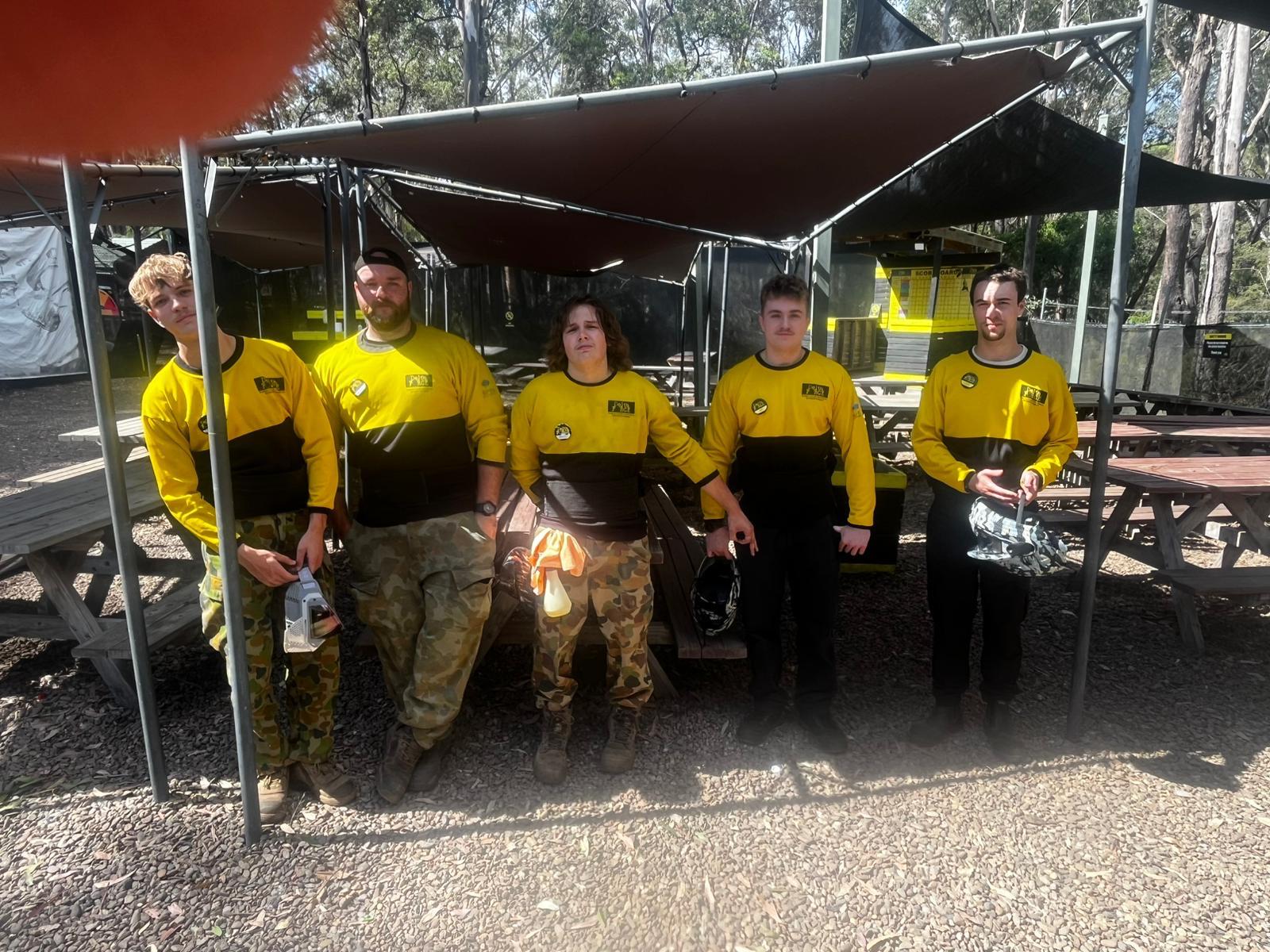 A Delta Force marshal lineup outdoors at a paintball centre