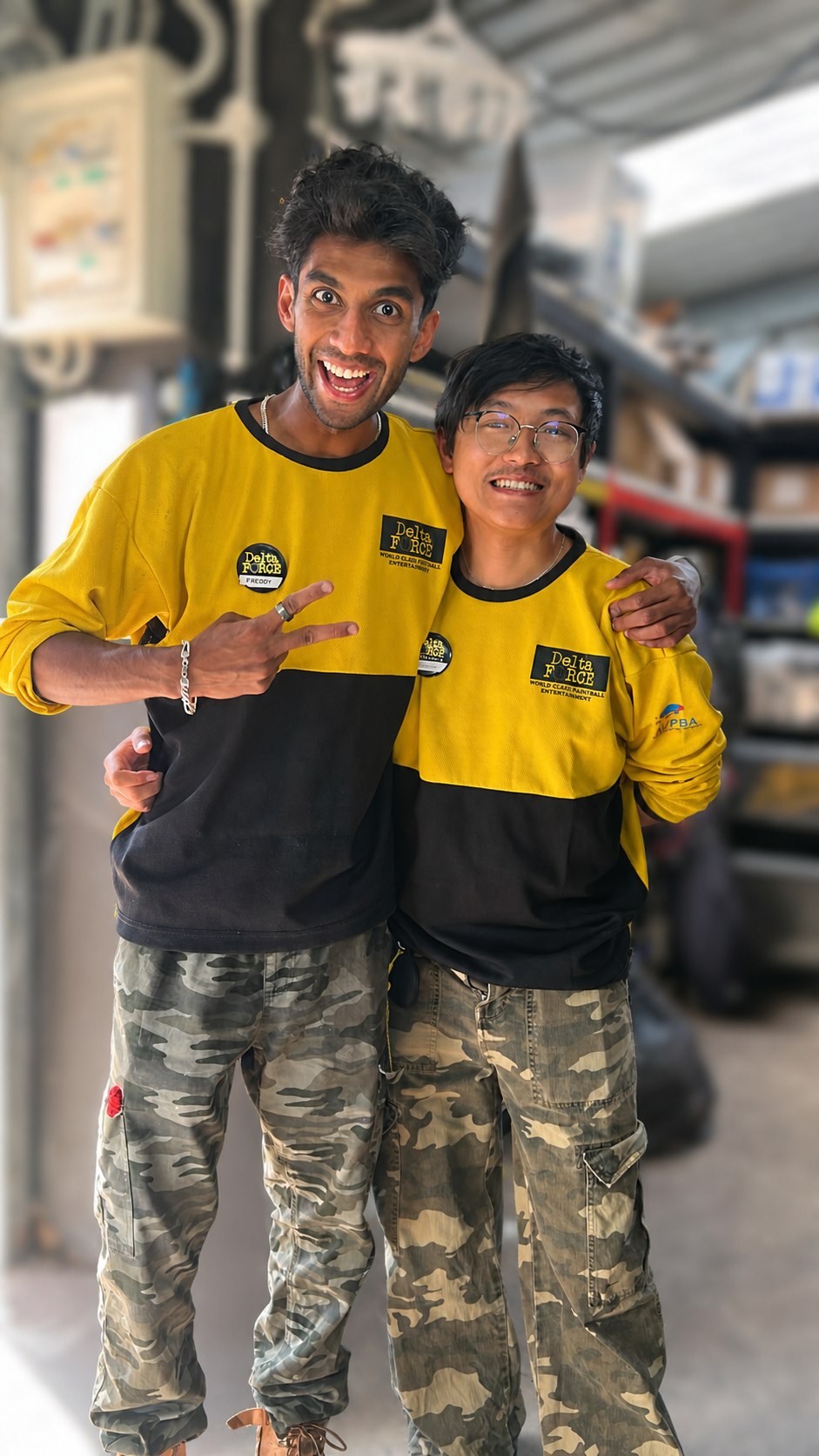 Two smiling Delta Force marshals with the operations area softly blurred behind them